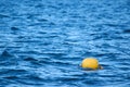 Yellow buoy on the sea waves background