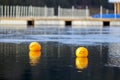 Yellow buoys against the blue water. Restriction on open water. Royalty Free Stock Photo