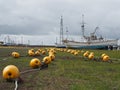 Yellow buoys and beacons on seaside harbour in fishing village on cloudy day on Hokkaido island, northern Japan Royalty Free Stock Photo