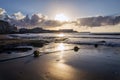 Yellow buoys on rope lying on sandy beach with small waves on sea and beautiful clouds during sunrise, sunny summer morning Royalty Free Stock Photo