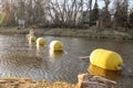 Yellow buoys, tied by a rope, lie on the water