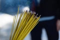 Yellow burning incense sticks outdoors