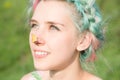 Yellow butterfly sitting on the nose Cute young girl on nature. Harmony and enjoyment in nature Royalty Free Stock Photo