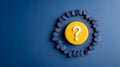 A yellow button with a question mark on it surrounded by blue pills in a circle, all against a dark blue background Royalty Free Stock Photo