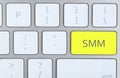 Yellow button with word SMM on computed keyboard, top view Royalty Free Stock Photo