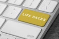 Yellow button with words Life Hacks on computer keyboard, closeup Royalty Free Stock Photo