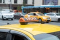 Yellow cab with taxi sign on the roof parked on the city street waiting for passengers to pick up.The taxi is parked on the street Royalty Free Stock Photo