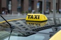 Yellow cab with taxi sign on the roof parked on the city street waiting for passengers to pick up.The taxi is parked on the street
