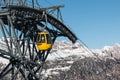 Yellow cable car ski lift going up on the mountain top Royalty Free Stock Photo