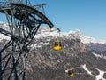 Yellow cable car ski lift going up on the mountain top Royalty Free Stock Photo