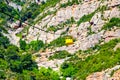 Yellow cable cars climbing Santa Maria de Montserrat abbey in Monistrol, Catalonia, Spain