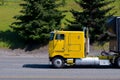 Yellow cabover big rig semi truck old model on road Royalty Free Stock Photo