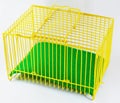Yellow cage and green sheet for tiny pet Royalty Free Stock Photo