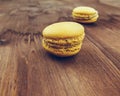 Yellow cake macaron on wood background, maccarone sweet dessert