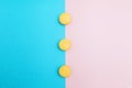 Yellow cakes on blue and pink background