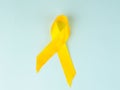 Yellow cancer awareness ribbon as symbol of childhood cancer awareness, Support the Troops Ribbon Royalty Free Stock Photo