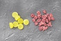 Yellow candies and dried cranberries on grey background