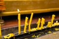 Yellow candles burning at a traditional Thai Buddhist .Thailand.