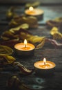 Yellow candles and dried flower petals Royalty Free Stock Photo