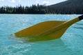 Yellow canoe paddle in the teal water of Emerald Lake in Yoho National Park Canada Royalty Free Stock Photo