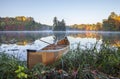 Yellow canoe on shore of calm lake with island and trees in fall color in northern Minnesota Royalty Free Stock Photo