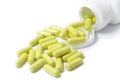 Yellow capsule pills supplement spilled isolated Royalty Free Stock Photo