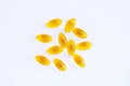Yellow capsules with oil on white background. Medicines and nutritional supplements