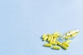 Yellow capsules are poured out of a bottle on a blue background. Omega-3 vitamins. food Supplement. Fish oil in capsules Royalty Free Stock Photo
