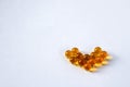 Yellow capsules of vitamins in the shape of a heart Royalty Free Stock Photo