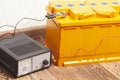 yellow car battery with car battery charger