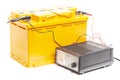 yellow car battery with car battery charger isolated on white background Royalty Free Stock Photo