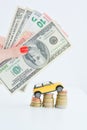 Yellow car climbing on pile of coins suggesting increase of sales Royalty Free Stock Photo