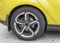 Yellow car closeup - rear wheel with light alloy rim Royalty Free Stock Photo