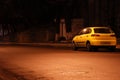 Yellow car in empty night street Royalty Free Stock Photo