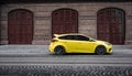 yellow Ford Focus in front of garage doors