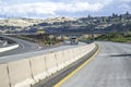 Yellow car hauler big rig semi truck with empty semi trailer running on the highway with overpass road intersections