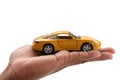 Yellow car in the men`s hands on a white background Royalty Free Stock Photo