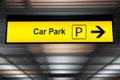 Yellow car park sign with arrow pointing to car parking zone