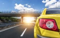 Yellow car rushing along a high-speed highway. Royalty Free Stock Photo