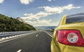 Yellow car rushing along a high-speed highway. Royalty Free Stock Photo