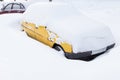 Yellow car under snow in snowbank Royalty Free Stock Photo