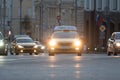 Yellow car of Yandex taxi service moving alone road in city downtown Royalty Free Stock Photo