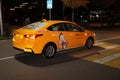 Yellow car Yandex taxi with a sticker from the cartoon