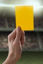 Yellow card with hand from referee giving a penalt