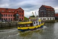 Yellow cargo barge sails along the canal in the Baltic Sea