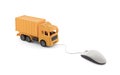 Yellow cargo delivery truck miniature connected to computer mouse on white
