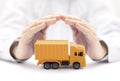 Yellow cargo delivery truck protected by hands