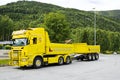 Yellow cargo truck with a trailer