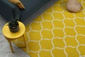 Yellow carpet with geometric pattern on floor in living room, above view Royalty Free Stock Photo