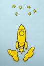 Yellow cartoon rocket flying to the stars